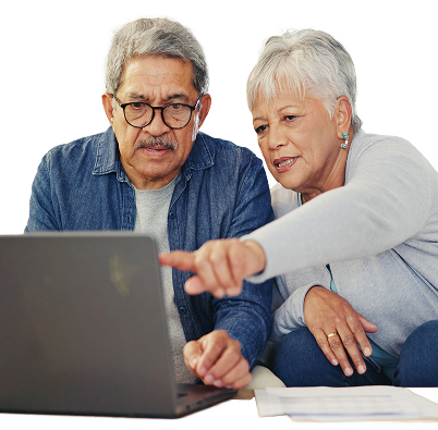 a lady pointing to a laptop screen while sitting next to her husband